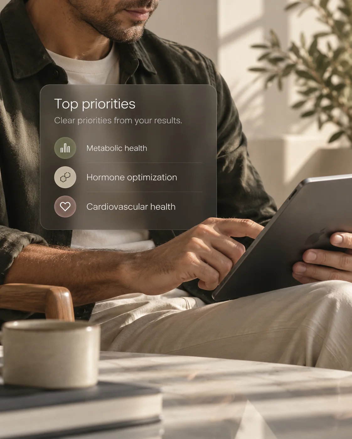 A person holding a tablet with a Top priorities panel listing Metabolic health, Hormone optimization and Cardiovascular health